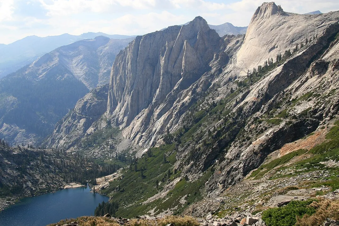 View looking down valley from the bowl under Kaweah Gap, Sequoia National Park, California. Shows Hamilton Lake, the Valhalla cliffs, and the High Sierra Trail switchbacking up.