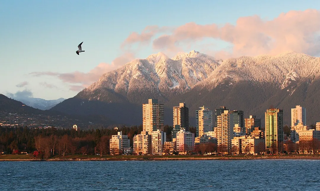View of Vancouver West End and the North Shore Mountaints at sunset. Seagull too.
