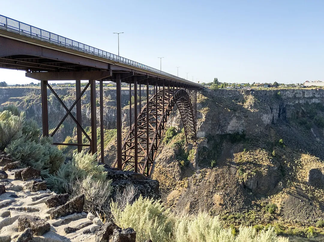 The I. B. Perrine Bridge is four-lane truss arch span in the western United States. Located at Twin Falls, Idaho, it carries U.S. Highway 93 over the Snake River Canyon, connecting to Jerome County and Interstate 84. 
The Perrine Bridge is approximately 1,500 feet (457 m) in total length, with a main span of 993 feet (303 m) and a deck height of 486 feet (148 m) above the Snake River it is the eighth highest bridge in the United States. The elevation above sea level for the bridge deck is approximately 3,600 feet (1,100 m). 
The bridge is named for I. B. Perrine (1861–1943), who spearheaded the early 20th century irrigation projects in the Magic Valley region and is largely credited as the main founder of Twin Falls; a statue of Perrine is at the visitors' center at the south end of the bridge. 
Originally named the Twin Falls-Jerome Intercounty Bridge, a steel cantilever bridge was opened to traffic 92 years ago in September 1927, and formally dedicated by governor H. C. Baldridge on October 1, 1927. The privately financed $750,000 structure was originally a toll bridge; the tolls were eliminated in April 1940 after the bridge was purchased by the state of Idaho for $482,000. 

By the early 1970s, the original bridge was outdated and unable to handle heavy loads and required replacement. Construction of the current bridge began in May 1973 and was completed in July 1976 at a cost of $10.56 million. The new bridge was dedicated on July 31, 1976; the original cantilever bridge to the west was later disassembled.