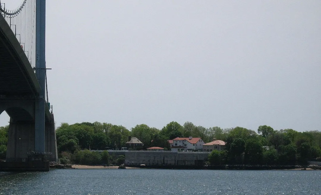 Houses in the Malba section of Whitestone, Queens as seen looking south from Ferry Point Park in The Bronx on a sunny early afternoon in springtime with just a zoom camera, not a telephoto lens.