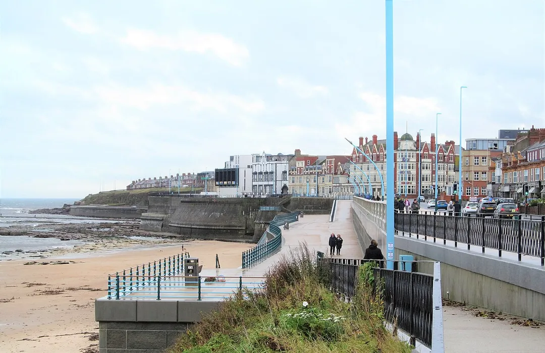 A few people braving the elements on an October day of high temperatures but also rain.