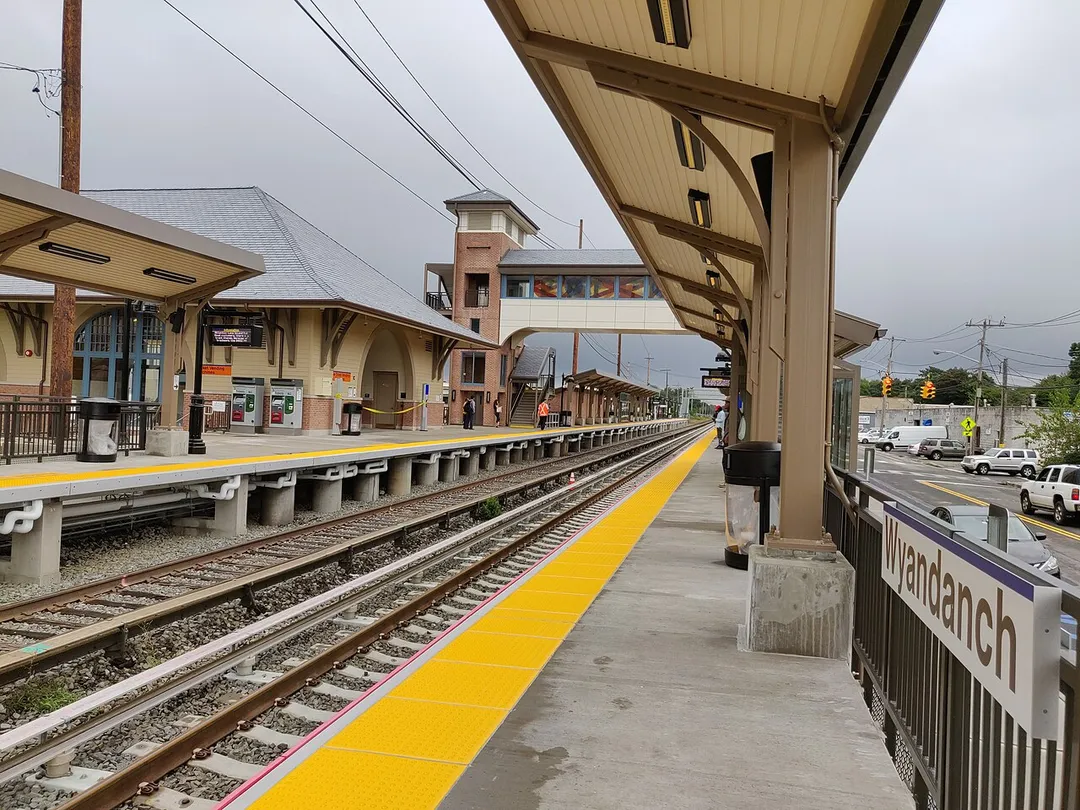 A recently (2018) completely rebuilt "Wyandanch" Station, which is part of the Long Island Rail Road. The new station house, heated platforms, second track (concrete ties), and wheelchair accessible overpass can be seen. The photographer is facing east on the east-bound platform ("B" Platform).