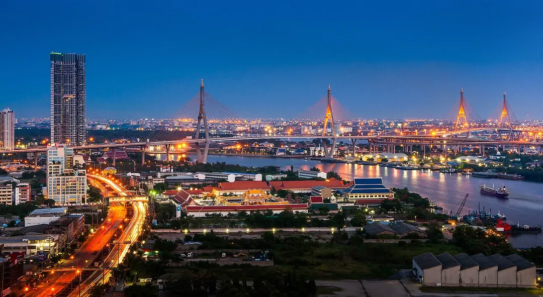 View along Rama III Road in Bangkok, with Wat Pariwat and Bhumibol Bridge