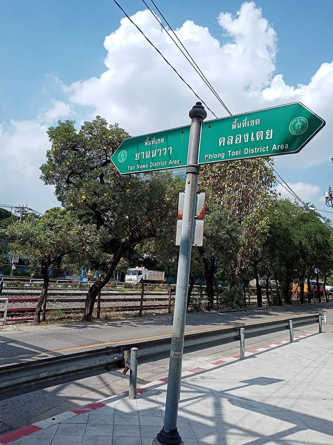 Dividing sign the area between Yan Nawa (Chong Nonsi subdistrict) and Khlong Toei (Khlong Toei subdistrict) districts on the corner of junction where Chuea Phloeng meets Rama III roads, opposite Maenam railway station, Bangkok.
The railroad tracks are the boundary lines.