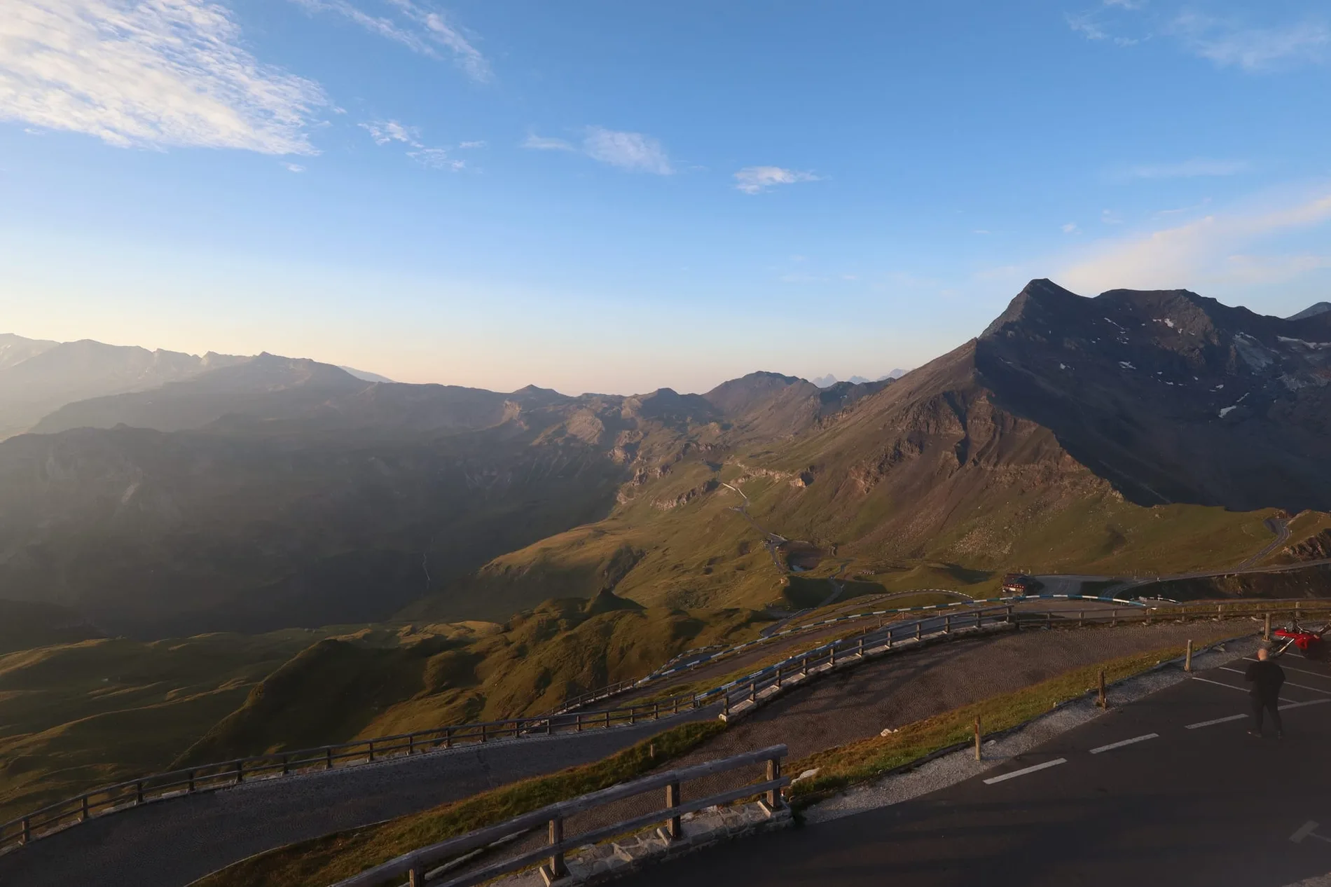 A parked car looking out over a mountain valley